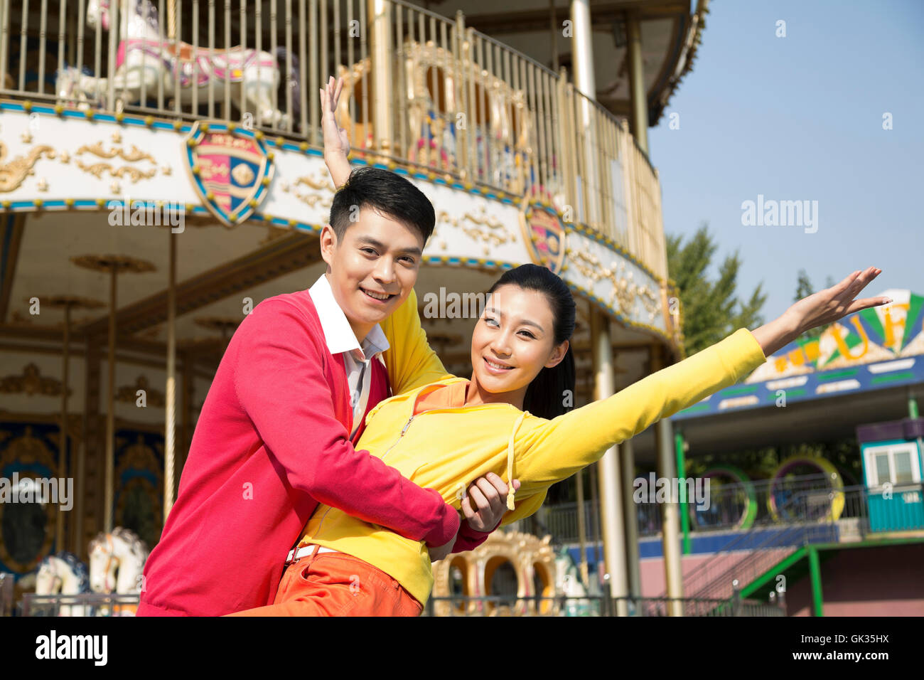 Young couple went to the amusement park Stock Photo - Alamy