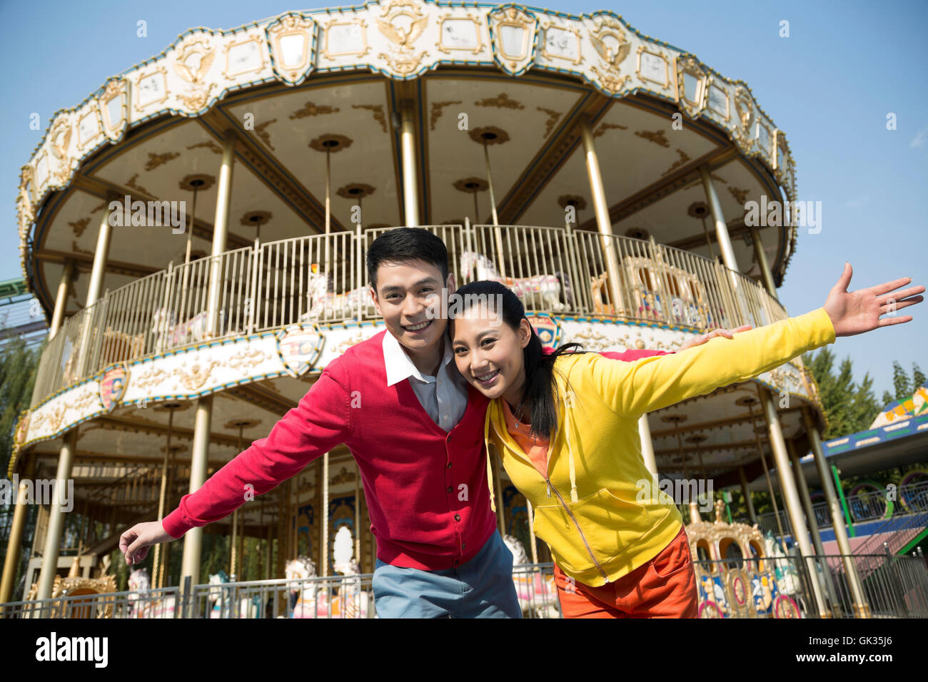 Young couple went to the amusement park Stock Photo - Alamy