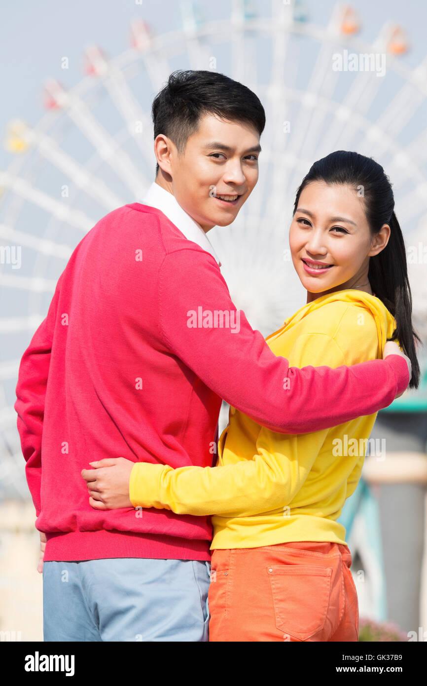 Young couple went to the amusement park Stock Photo - Alamy