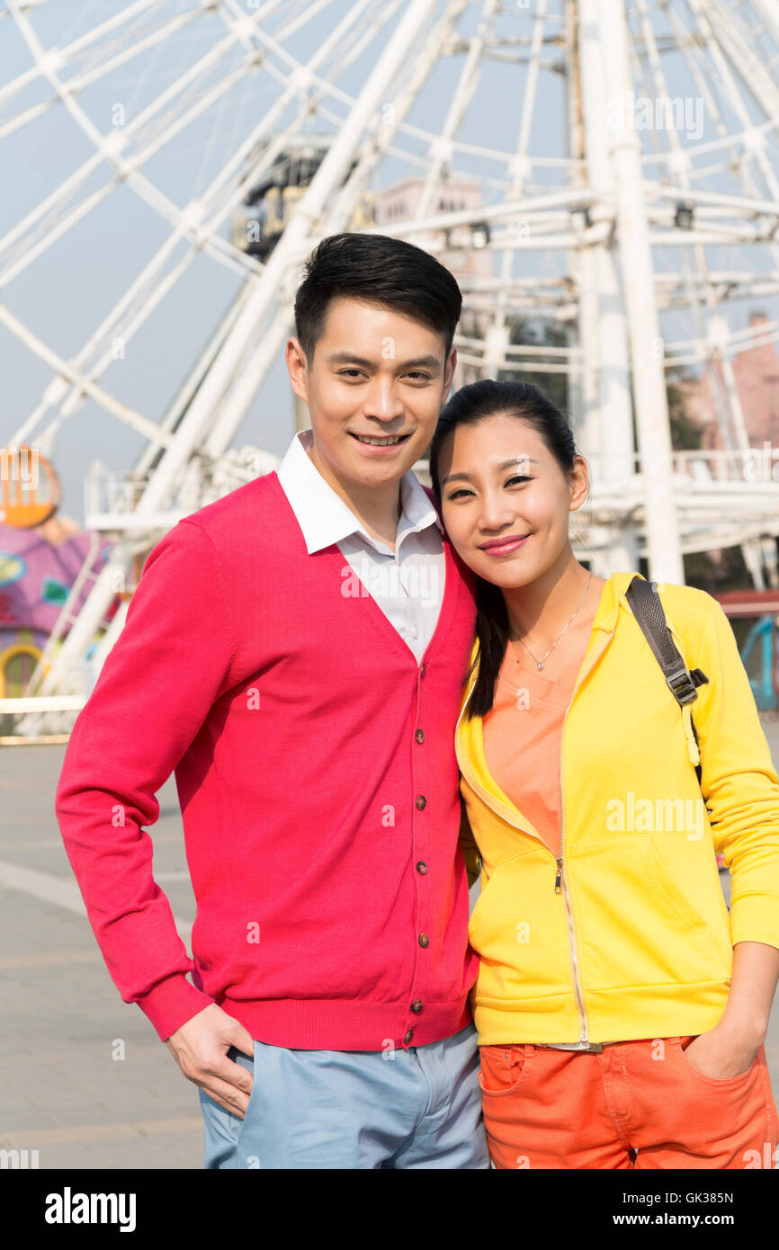 Young couple went to the amusement park Stock Photo - Alamy