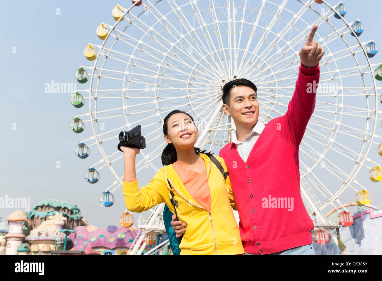 Young couple went to the amusement park Stock Photo - Alamy
