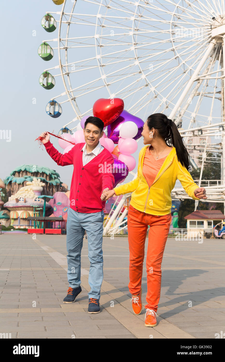 Young couple went to the amusement park Stock Photo - Alamy