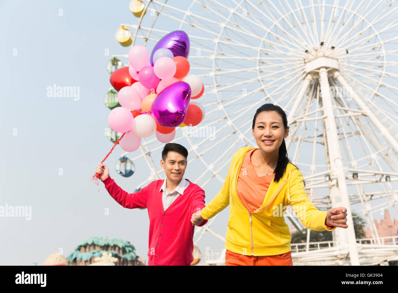Young couple went to the amusement park Stock Photo - Alamy