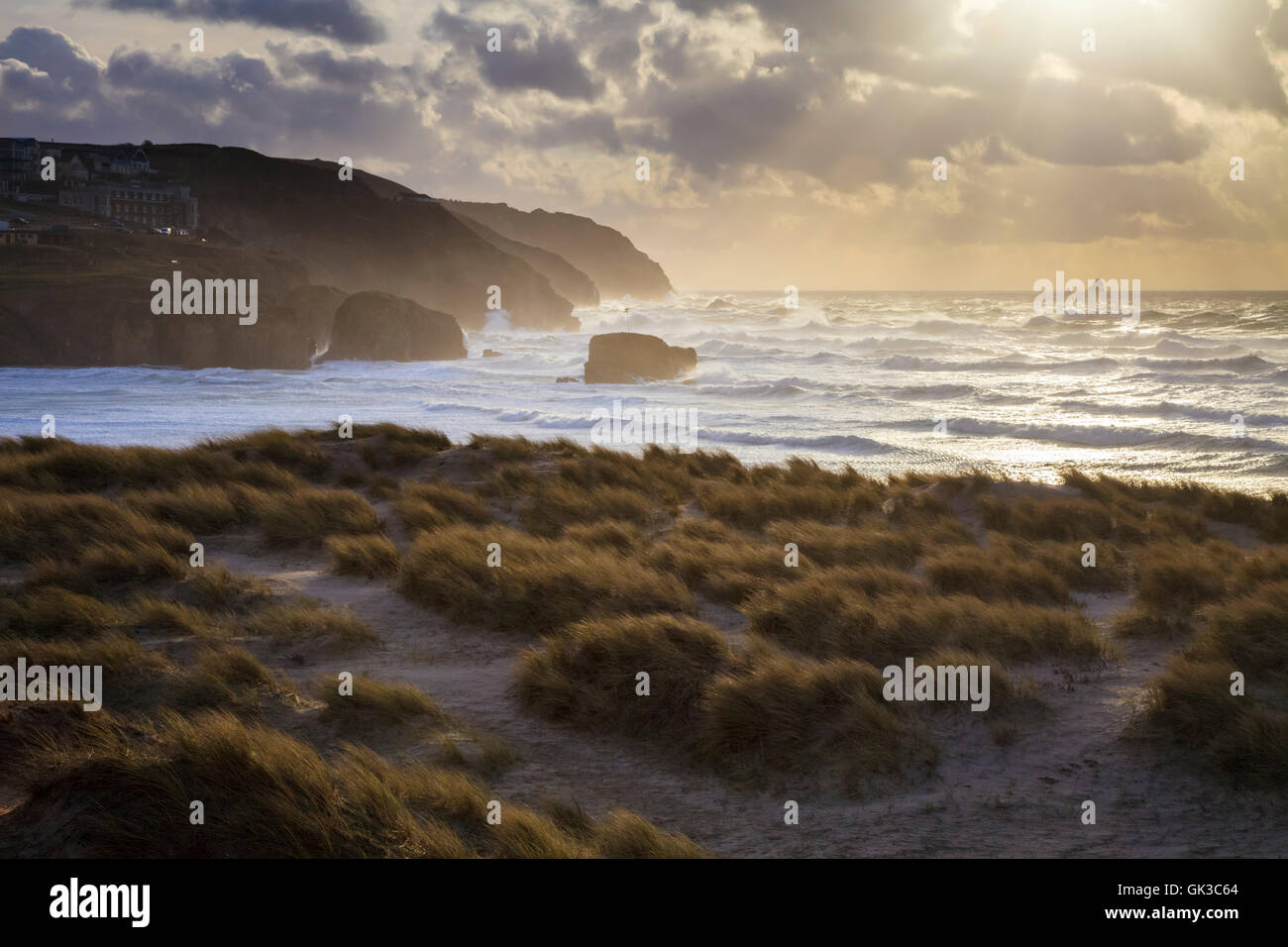 The setting sun captured from the sand dunes at Perranporth on the north coast of Cornwall. Stock Photo