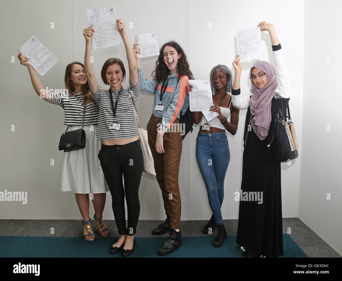 Students (left to right) Ana Cazacu (A,A,B), Lara Parizotto (3 A*'s), Nicoleta Andronic (A,A,A), Laima Barros (B,B,C) and Aysha Begum (A,B,B) celebrate after receiving their A-Level results at Westminster Kingsway College's King's Cross Centre, London. Stock Photo