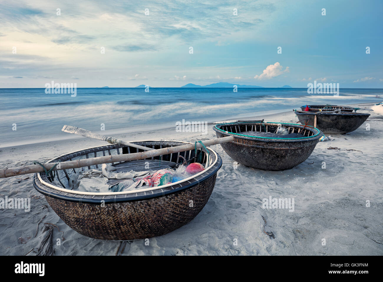 Traditional Vietnamese coracles at Cua Dai Beach at dusk. Hoi An, Quang Nam Province, Vietnam