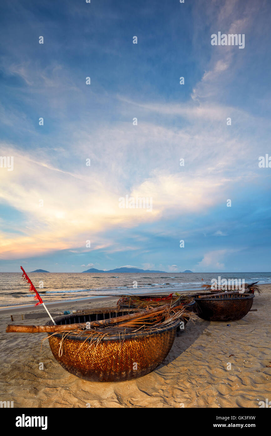 Traditional Vietnamese coracles at Cua Dai Beach at dusk. Hoi An, Quang Nam Province, Vietnam