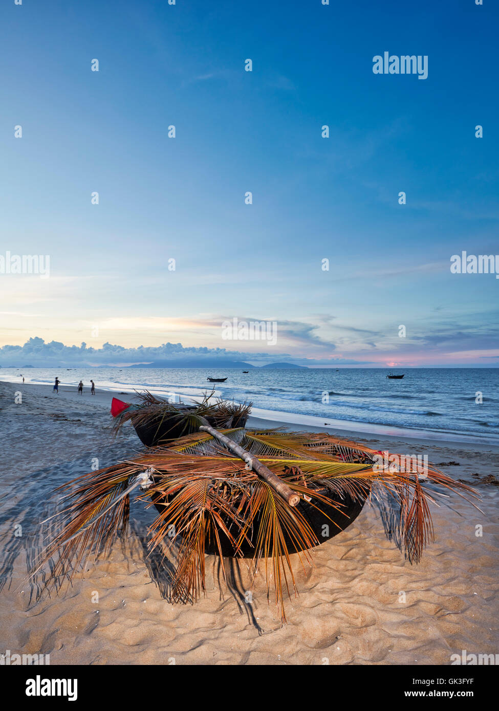 Traditional Vietnamese coracles at Cua Dai Beach at dusk. Hoi An, Quang Nam Province, Vietnam