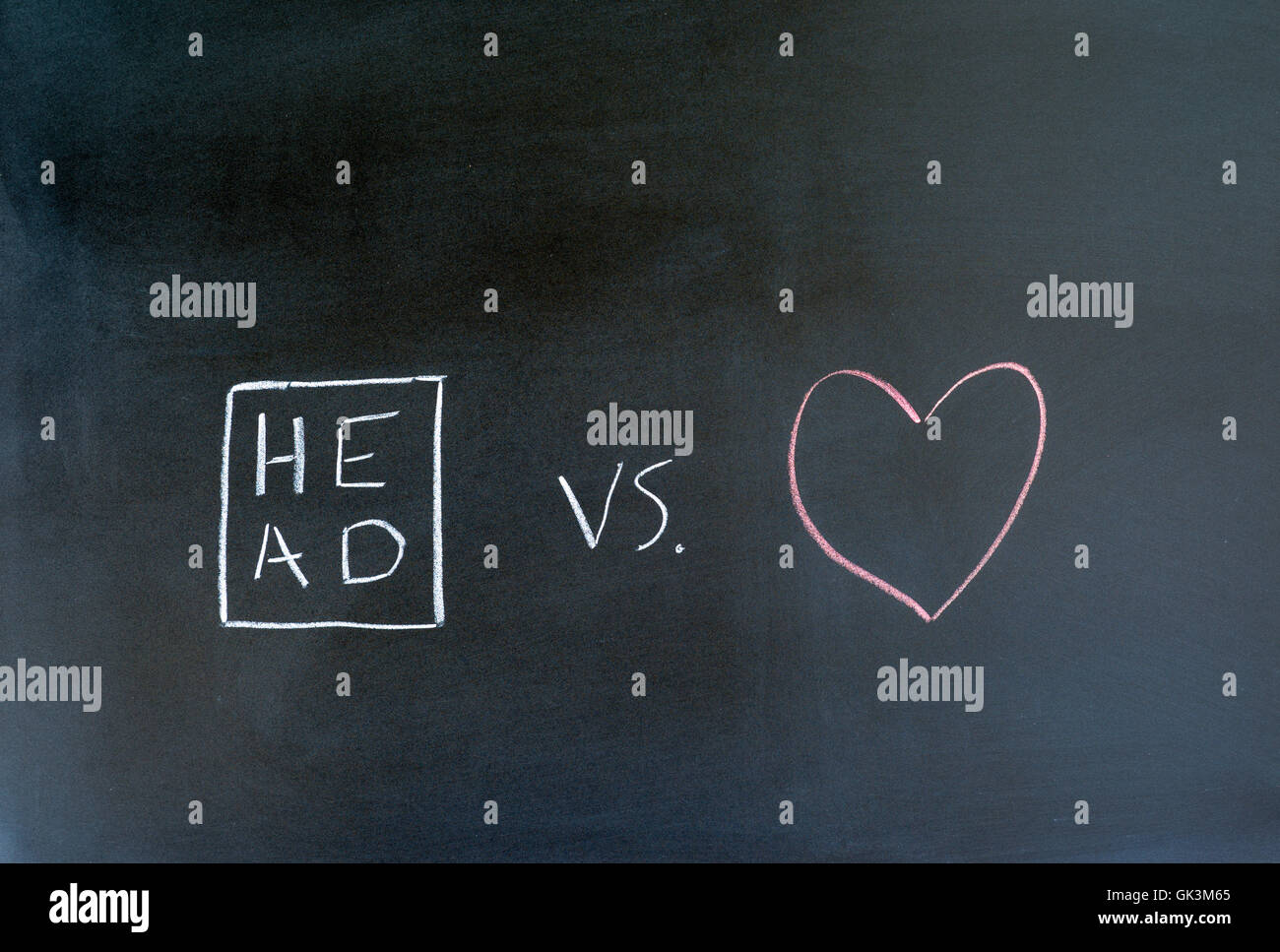 head and heart symbols drawn on a chalkboard. Stock Photo