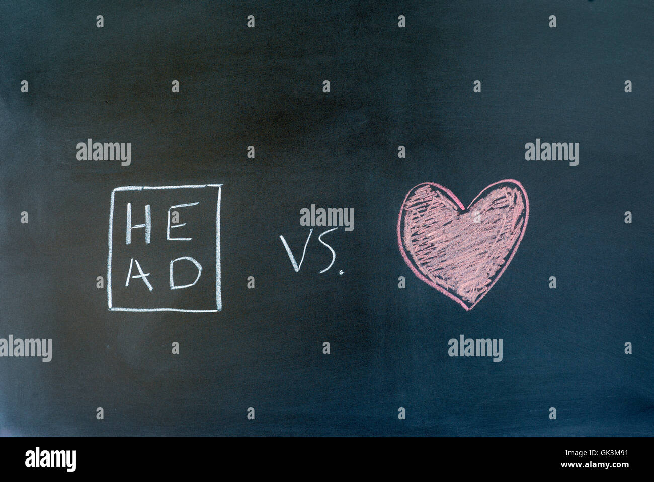 head and heart symbols drawn on a chalkboard. Stock Photo