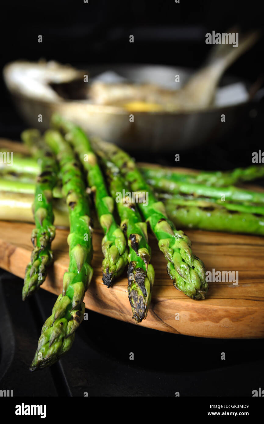 Roasted asparagus on wooden board Stock Photo