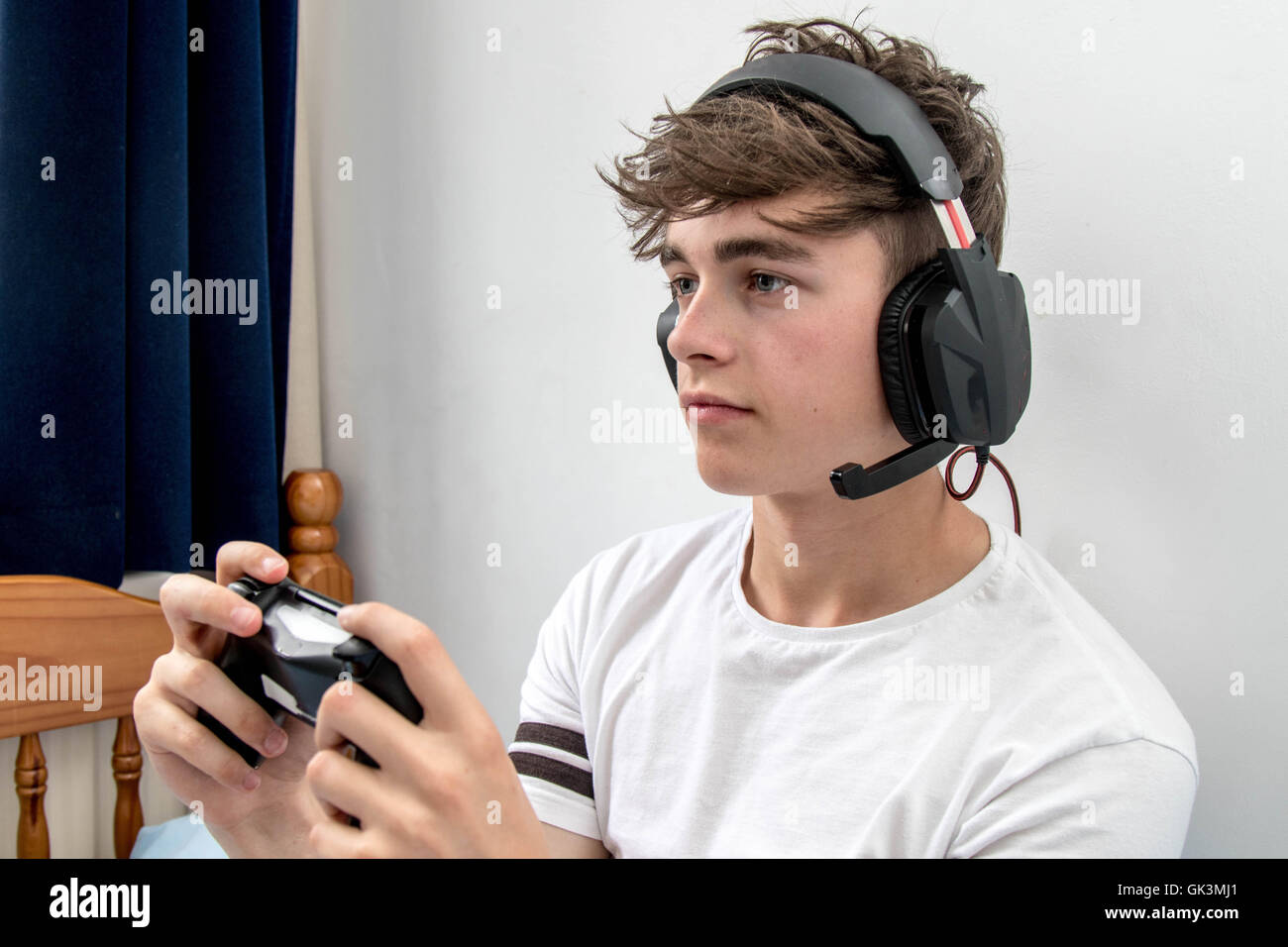 Teenage boy playing a video game Stock Photo