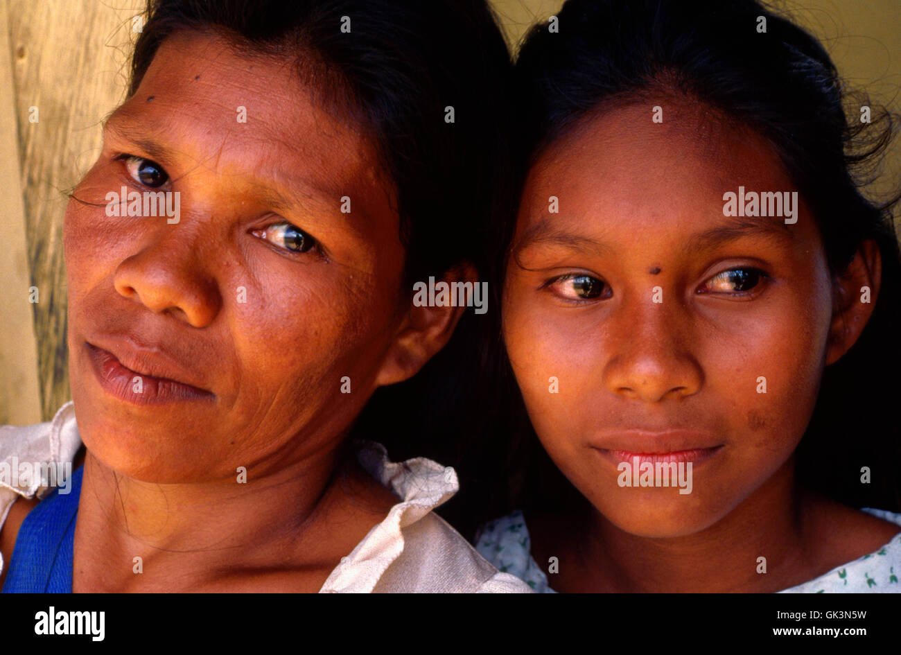 ca. 1980-1995, Colombia --- A Puerto Narino mother stands with her daughter, Amazonia, Colombia. | Location: Amazonia, Colombia. Stock Photo