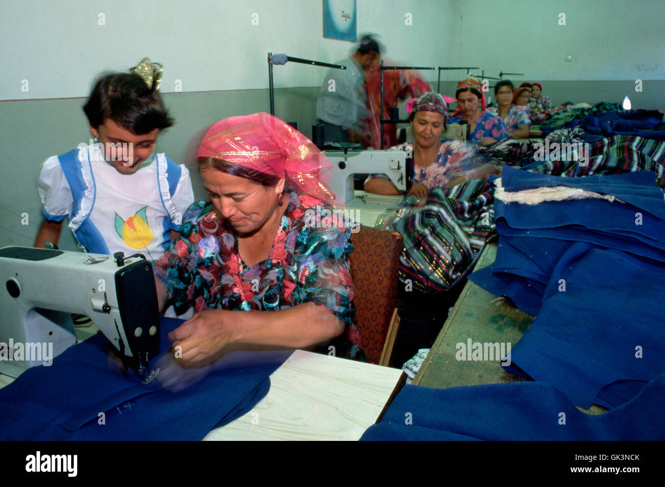 ca. 1980-1997, Marghilon, Uzbekistan --- Seamstresses make clothing in a factory sewing room. --- Image by © Jeremy Horner/Corbi Stock Photo