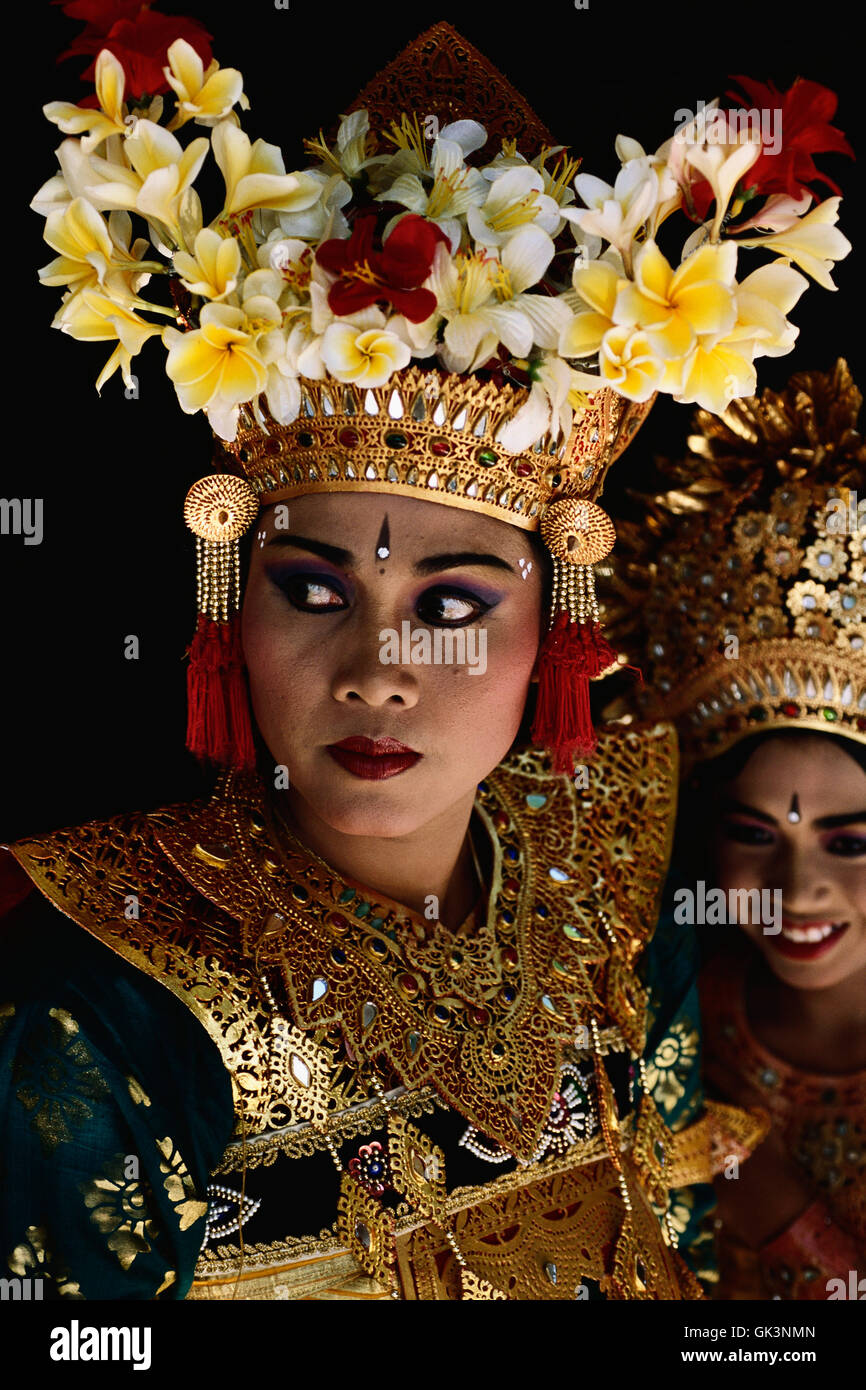 ca. 2000, Bali, Indonesia --- A Legong danger wears an elaborate costume of gold and jewels and a headdress decorated with frang Stock Photo