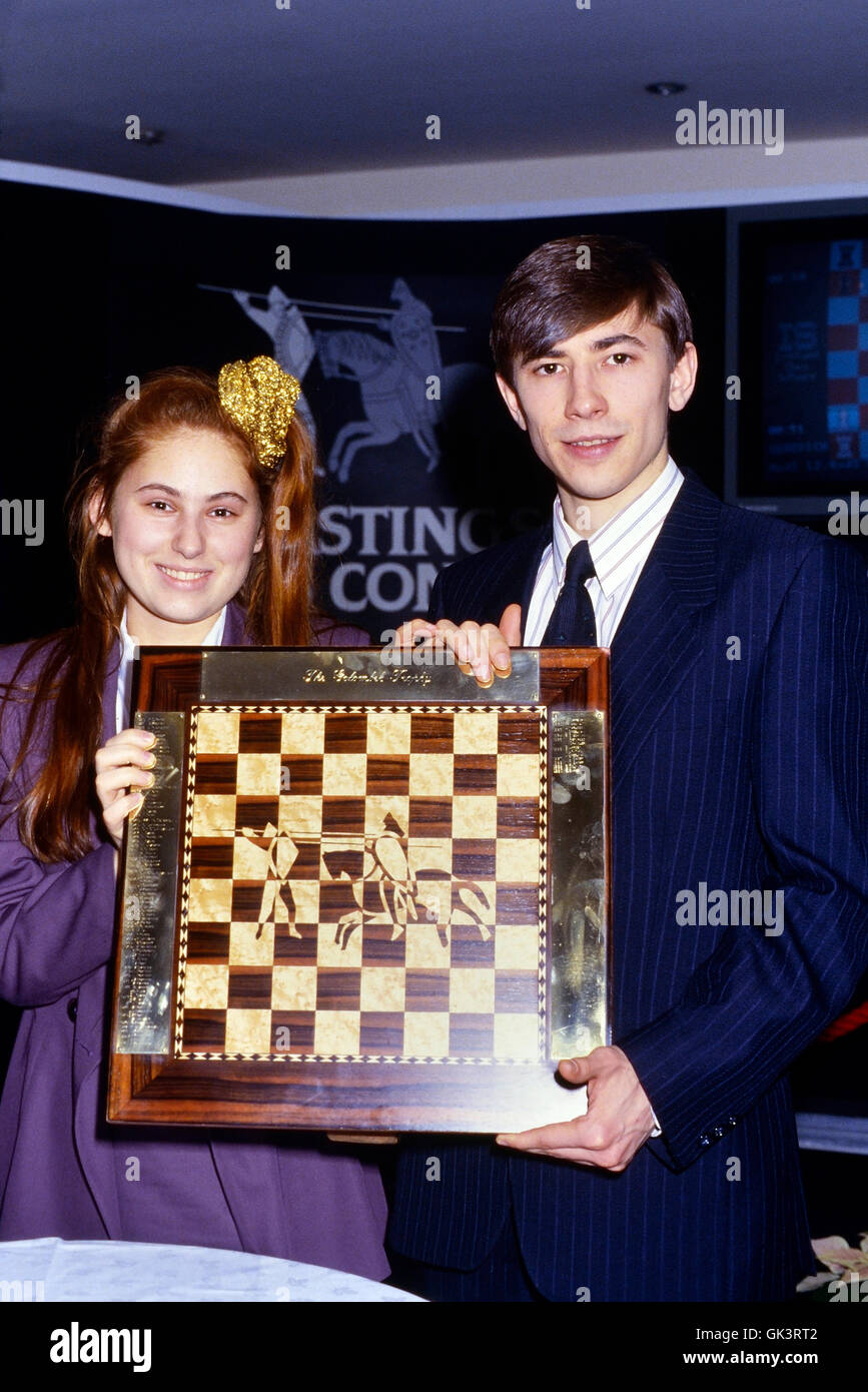 Judit Polgar and Evgeny Bareev holding the Golombek Trophy at the