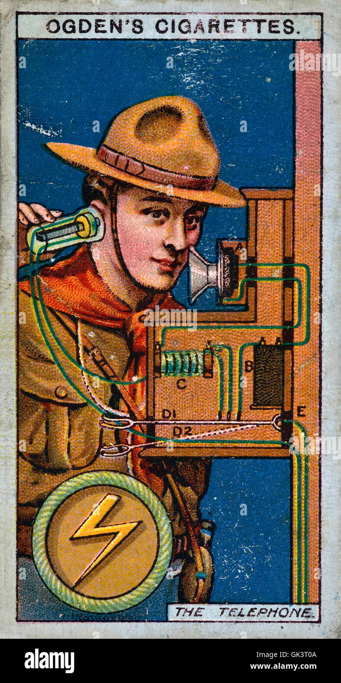 Ogden's cigarette card of a boy scout using a telephone Stock Photo