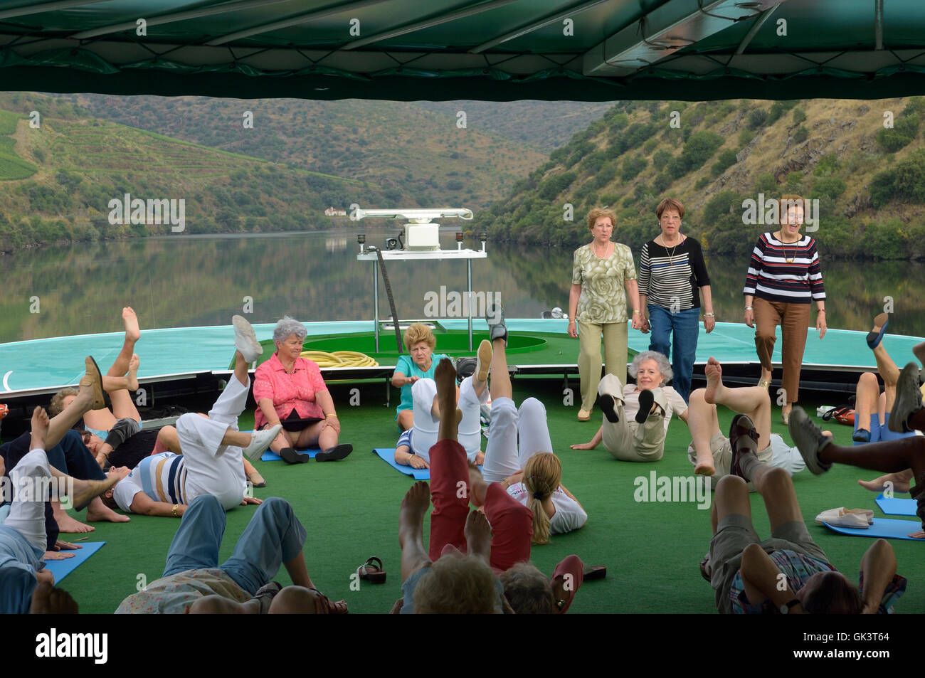 Stretching exercise class on the deck of Douro valley cruise ship ...