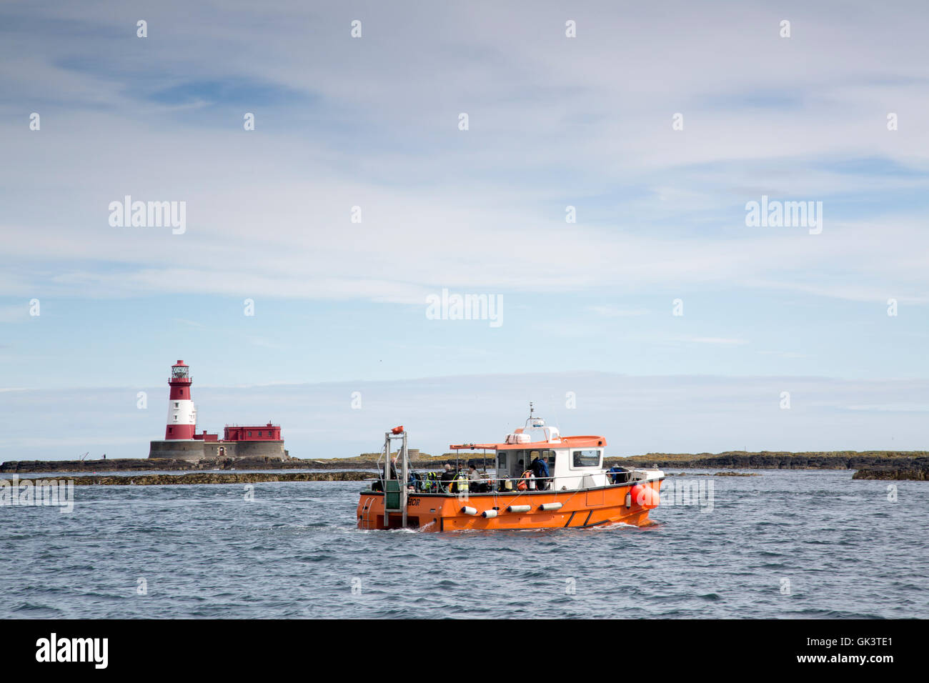 Diving Boat and Longstone Lighthouse, Outer Farne Island; Northumberland; England; UK Stock Photo