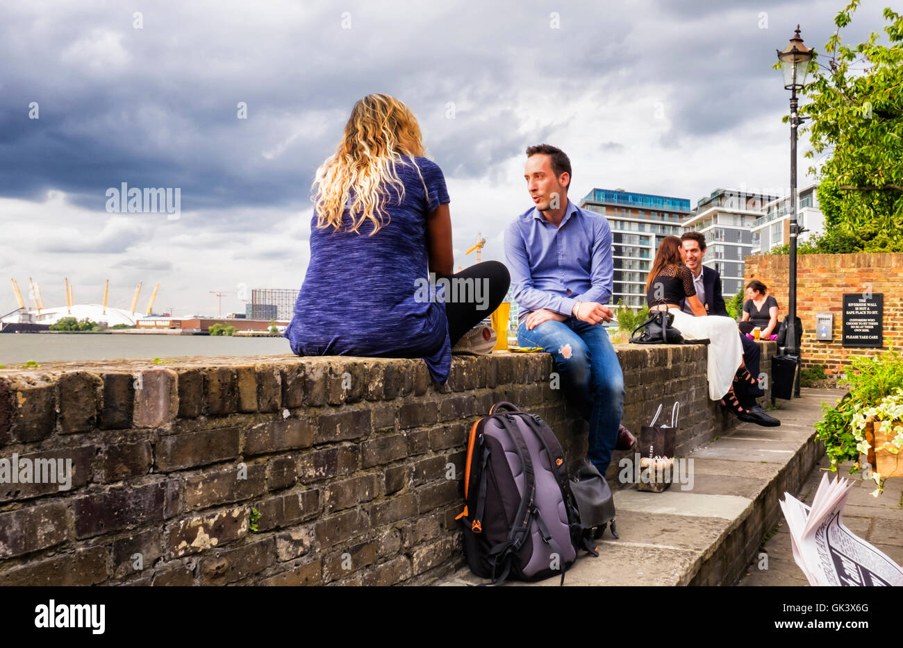 Young couples enjoy a drink after work at riverside pub after work, Greenwich, London Stock Photo