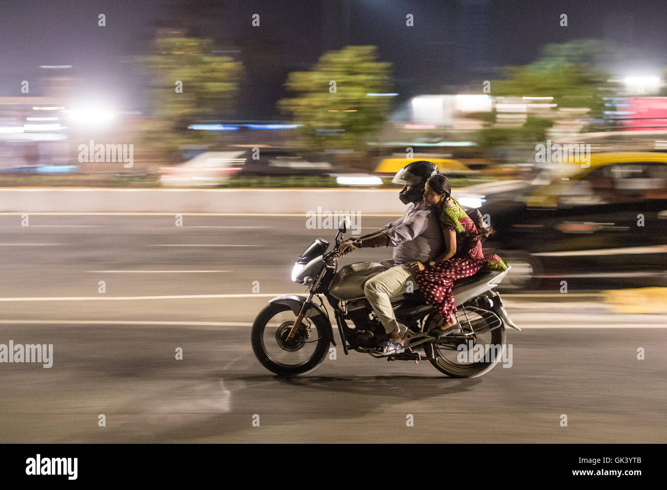 A man and women travel on a motorbike in Mumbai India  Credit: Euan Cherry Stock Photo