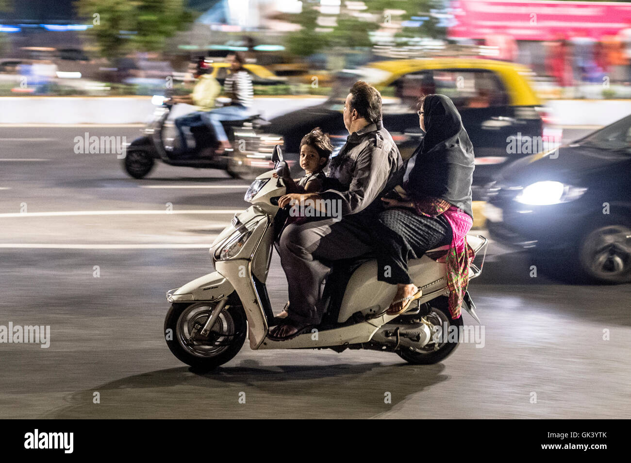 A family travel on a motorbike in Mumbai India  Credit: Euan Cherry Stock Photo