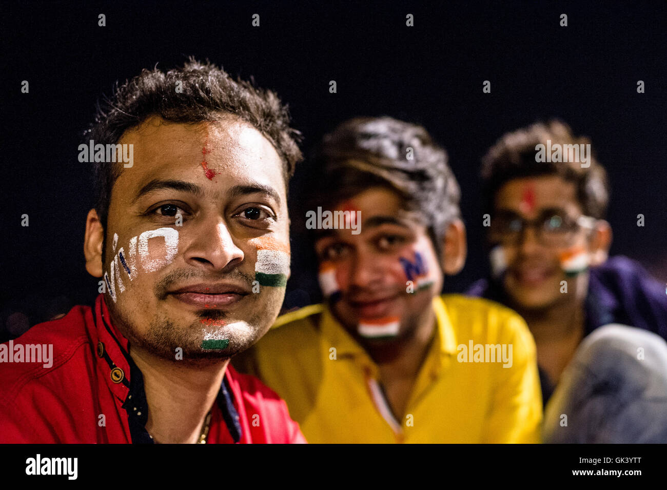 Three Indian men pose for a photograph after India plays cricket in Mumbai India  Credit: Euan Cherry Stock Photo