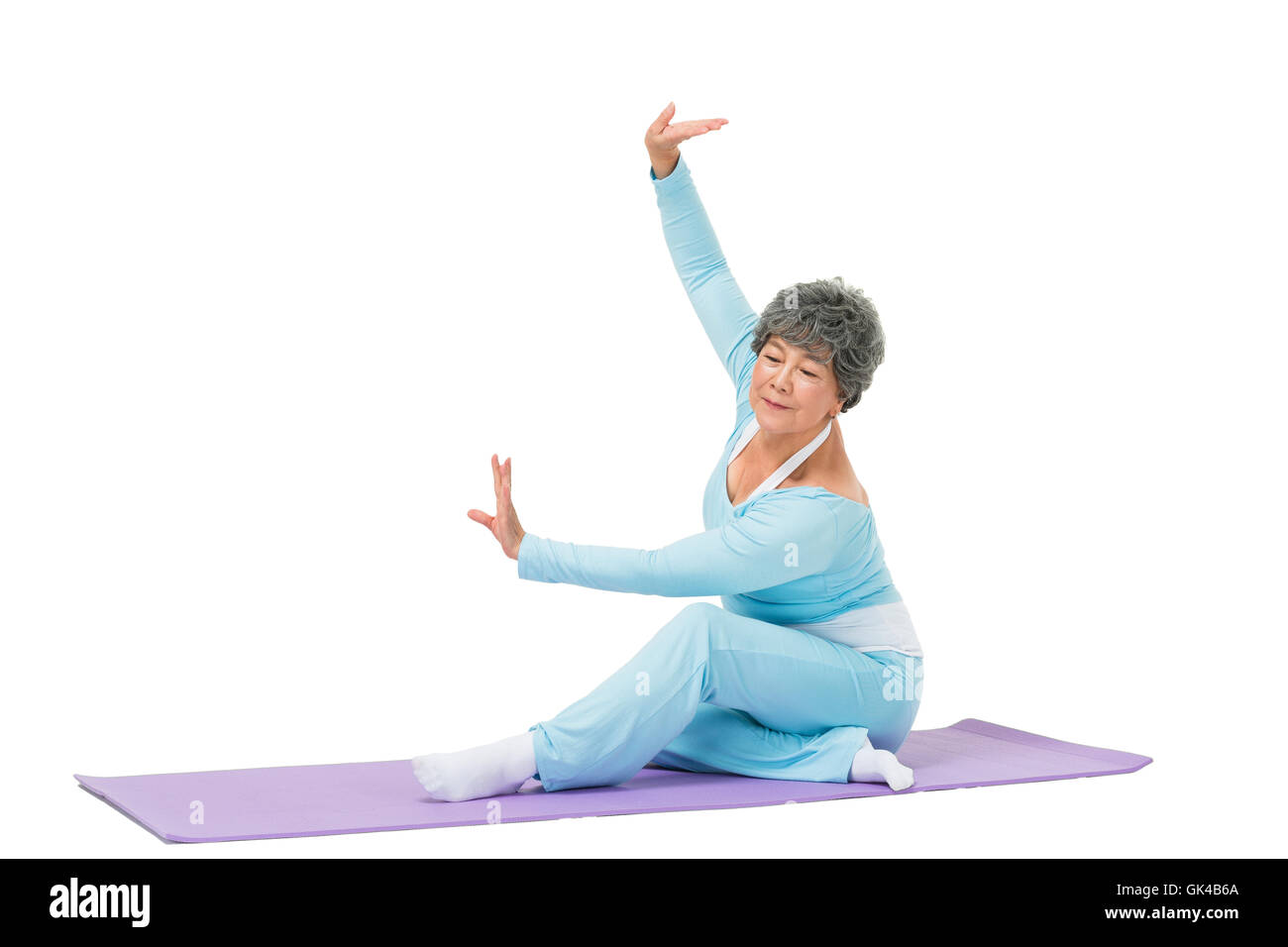 Elderly woman sitting on yoga mat Stock Photo Alamy