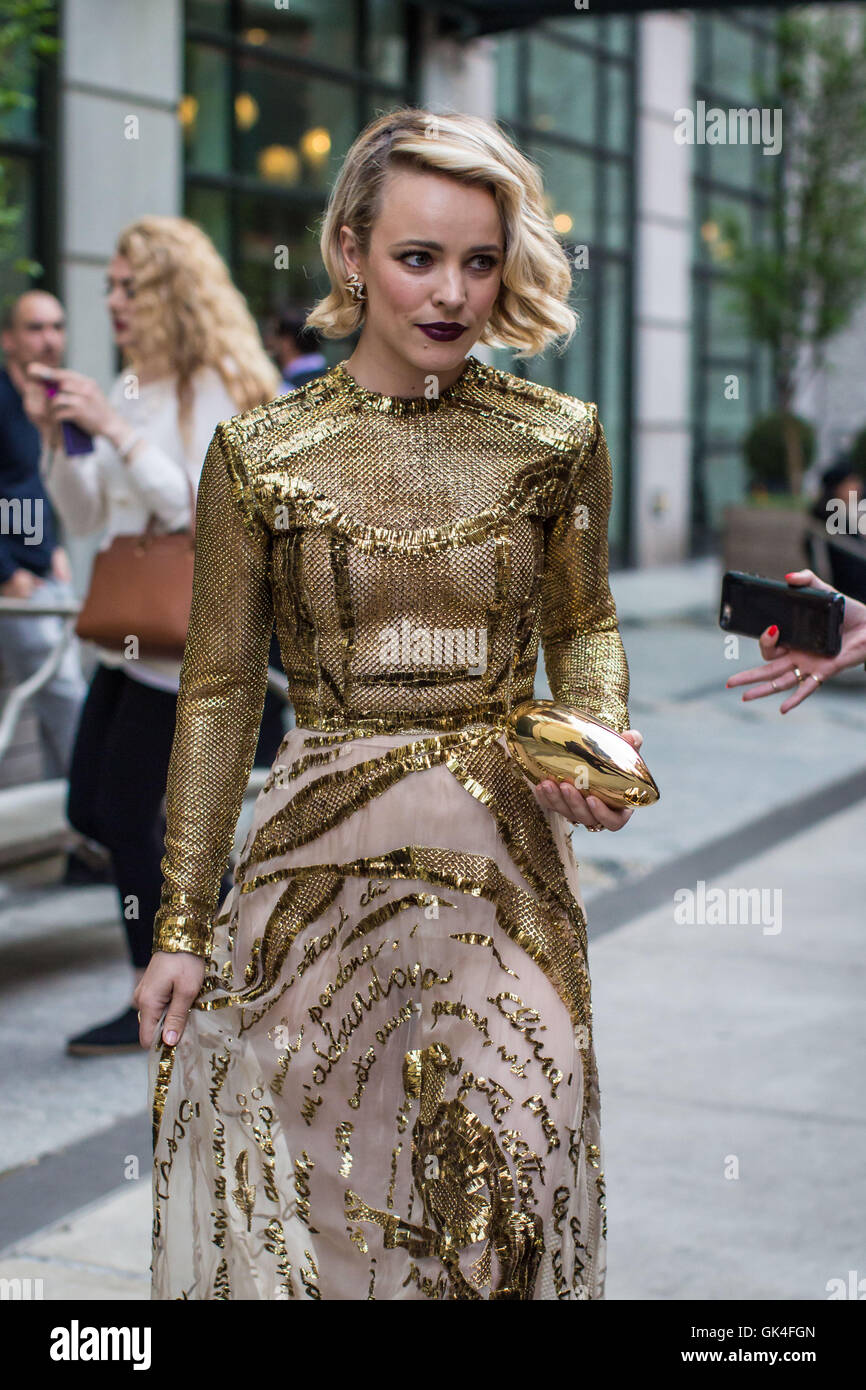 Rachel McAdams wears a gold mesh dress and dark purple lip as she makes