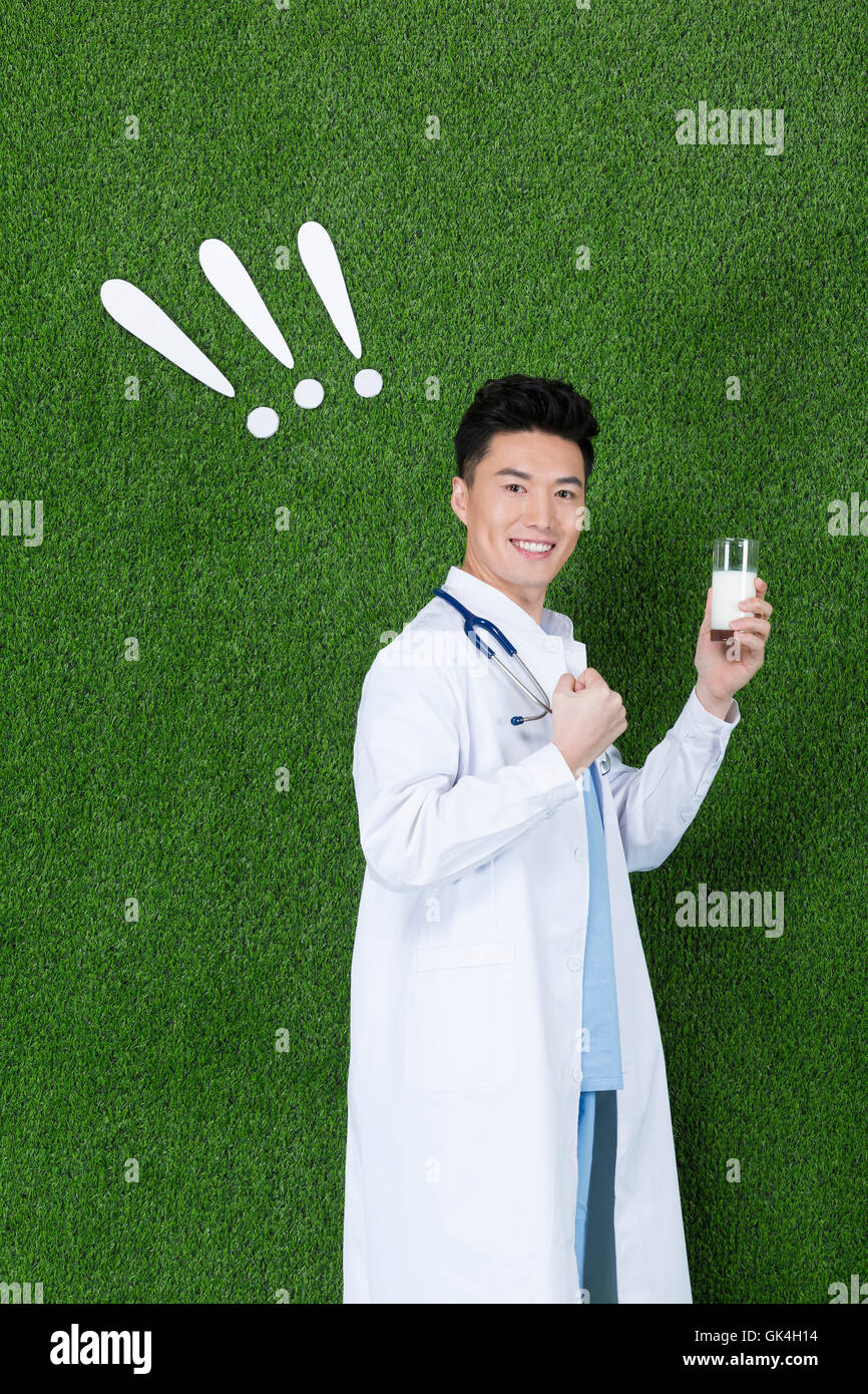 Grassland creative young male doctor holding milk Stock Photo Alamy