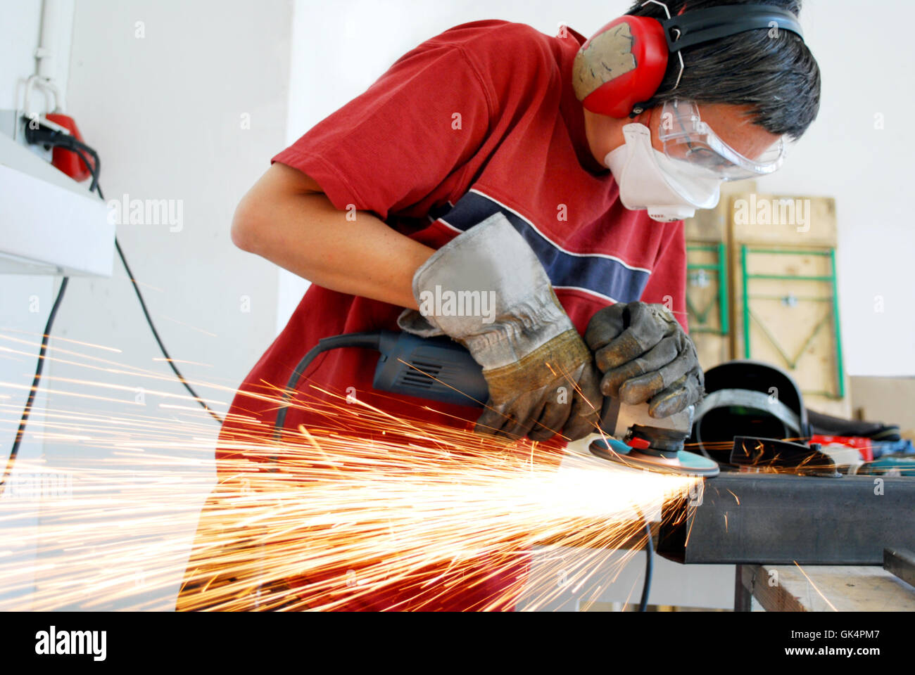 metal worker with a grinder and a lot of sparks Stock Photo
