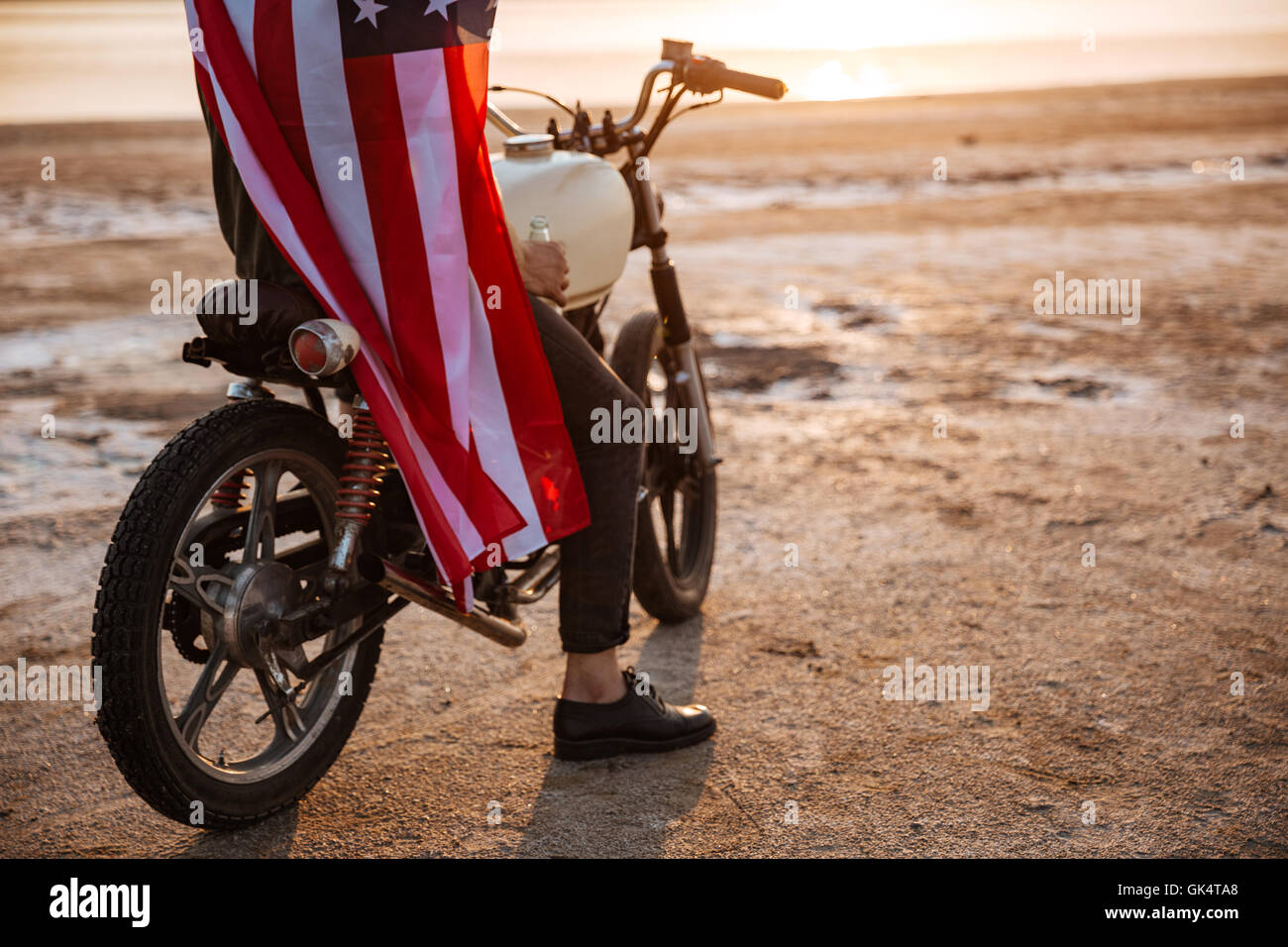 Cropped image of a brutal man wearing american flag cape sitting on his