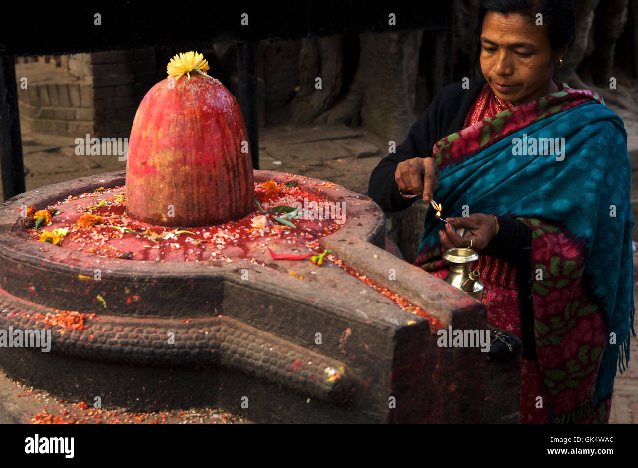 Bhaktapur, Nepal --- Puja being made at a shiva lingum, Bhaktapur, Kathmandu Valley, Nepal --- Image by © Jeremy Horner Stock Photo