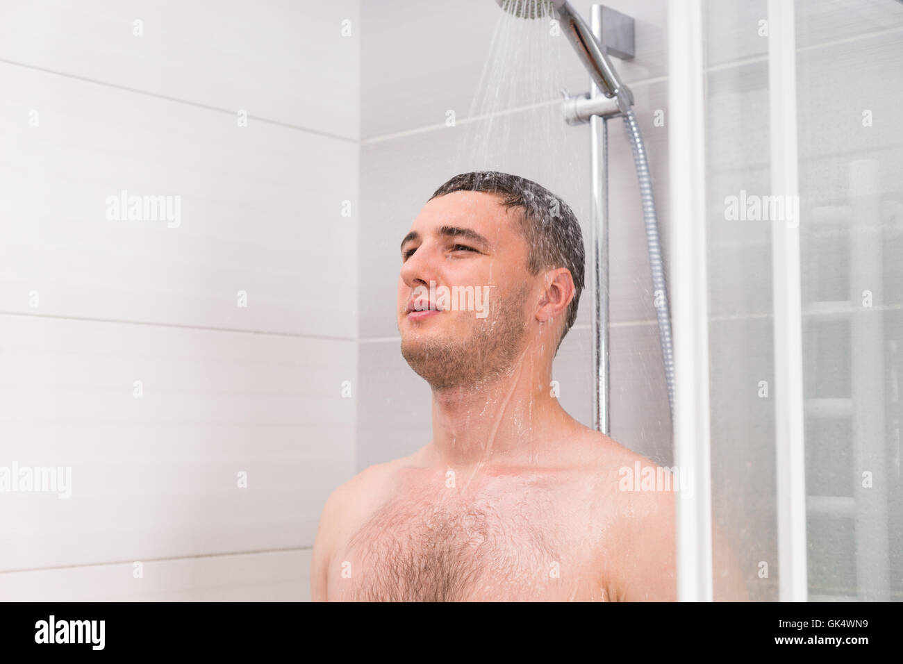 Pensive Young Man Taking A Shower And Thinking About Something