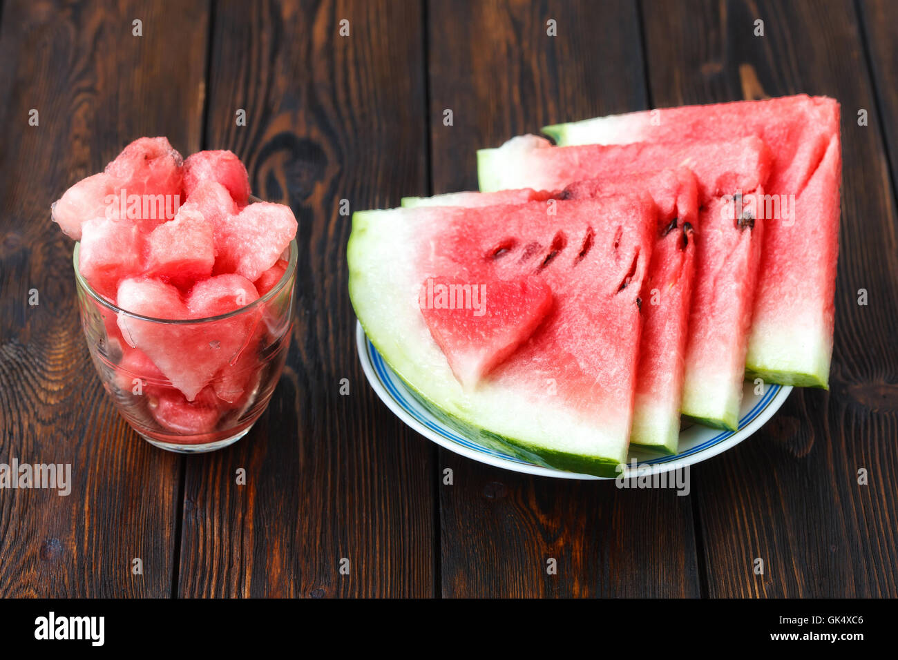 Slices of watermelon on plate and glass with heartshape Stock Photo