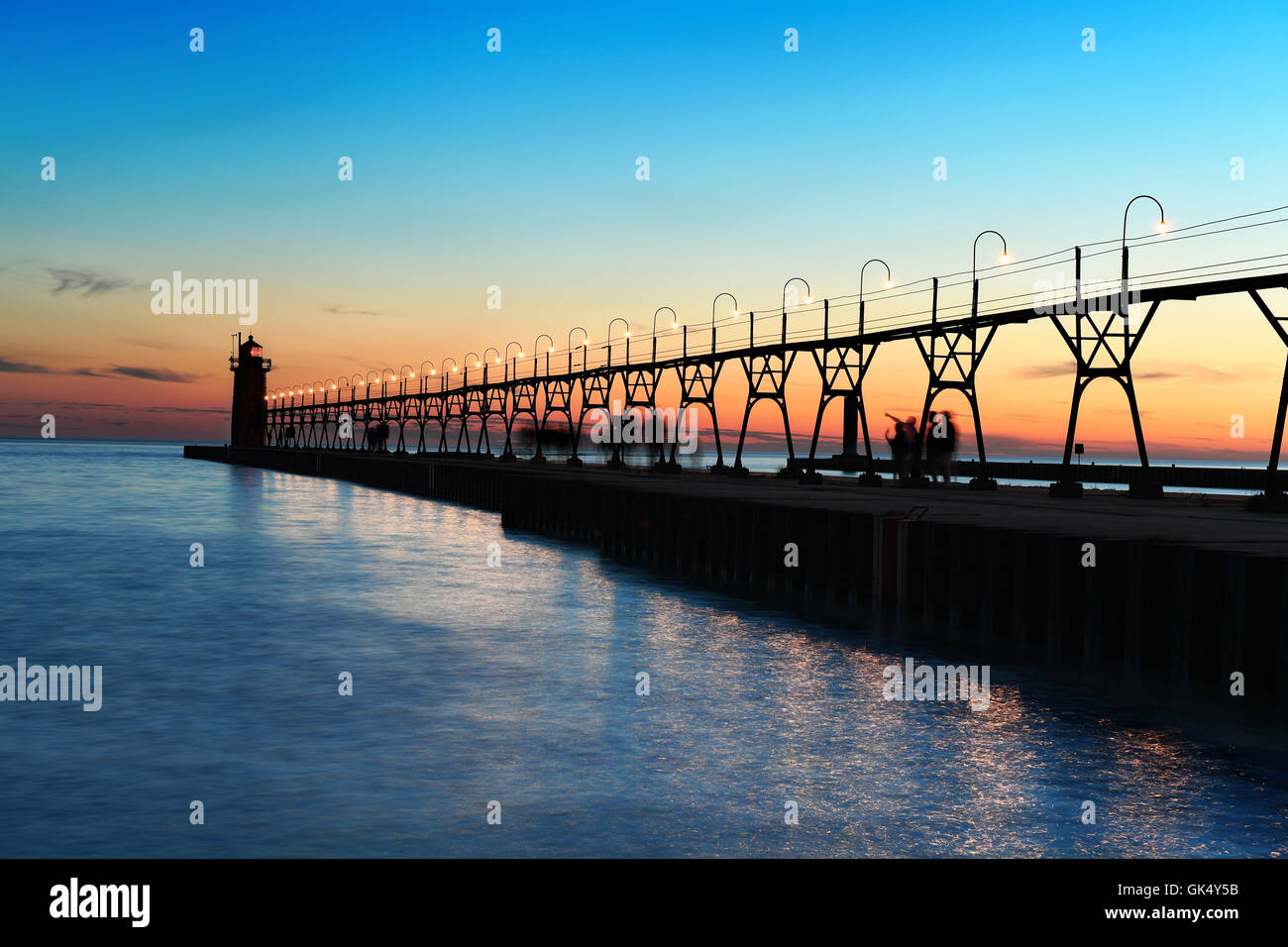 Sunset in South Haven Michigan with lighthouse and pier Stock Photo