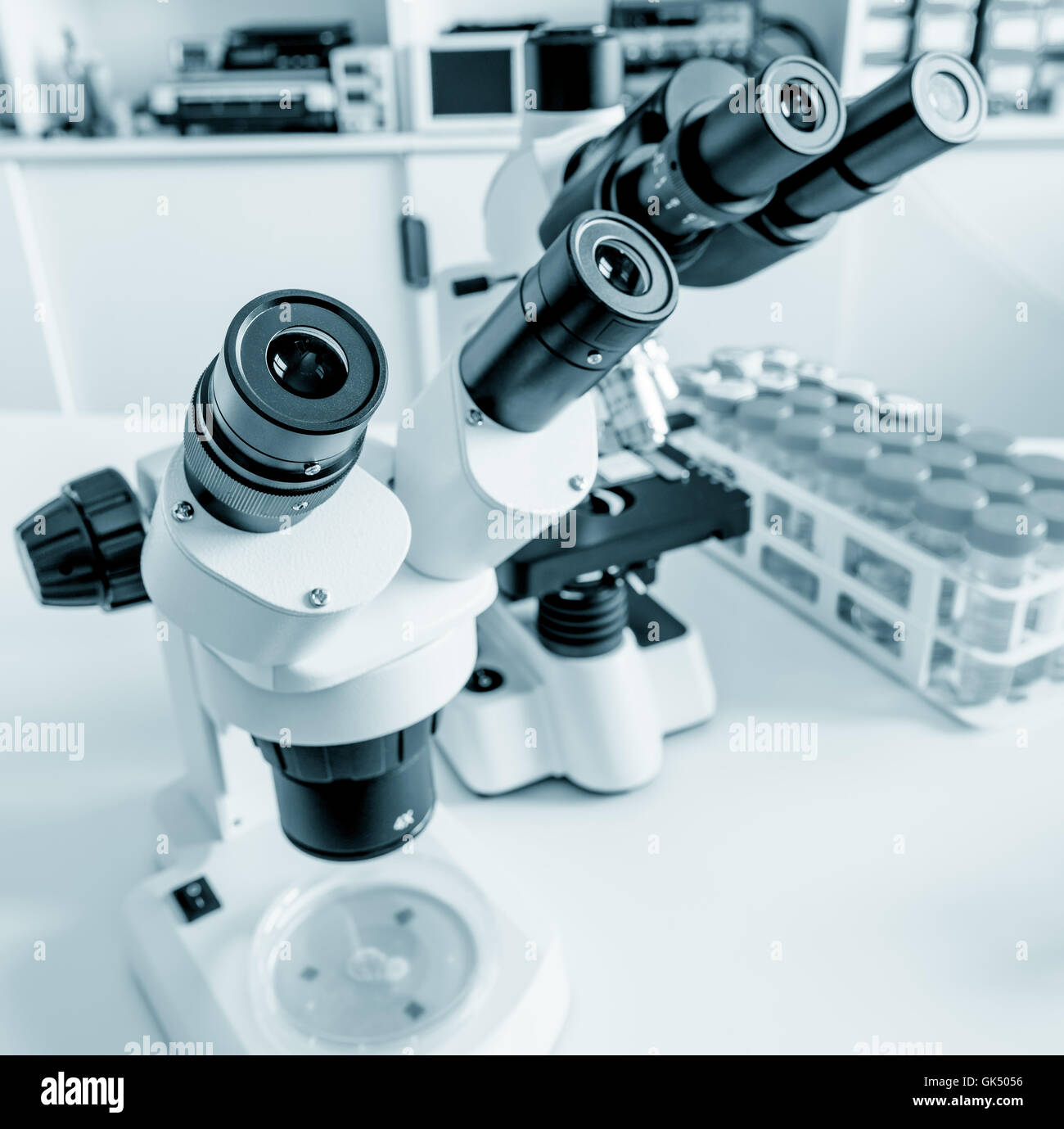Science microscope on lab bench. Microbiology laboratory. Blue toned