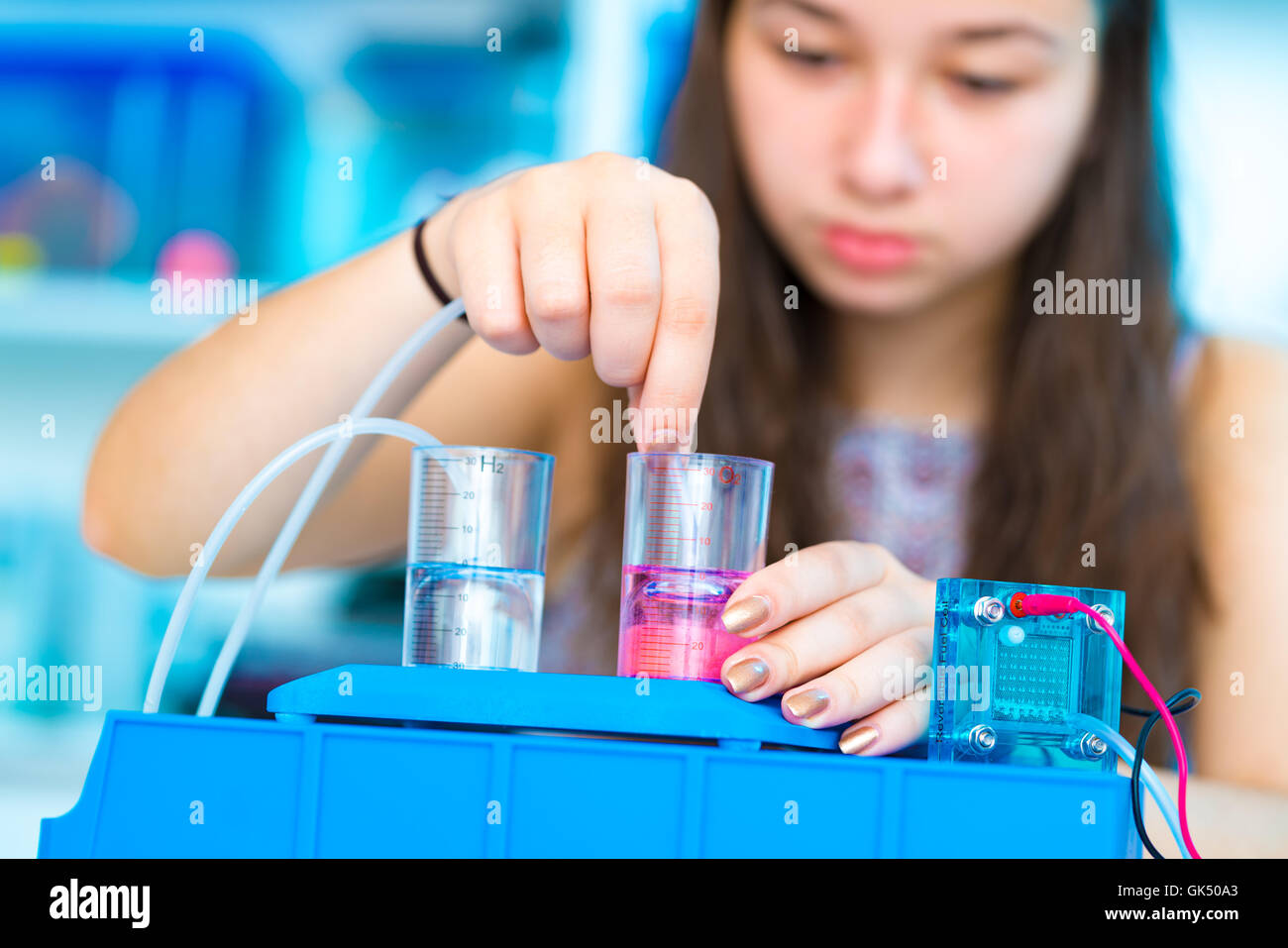 Student teen girl with experiment PEM proton exchange membrane reversible fuel-cell Stock Photo