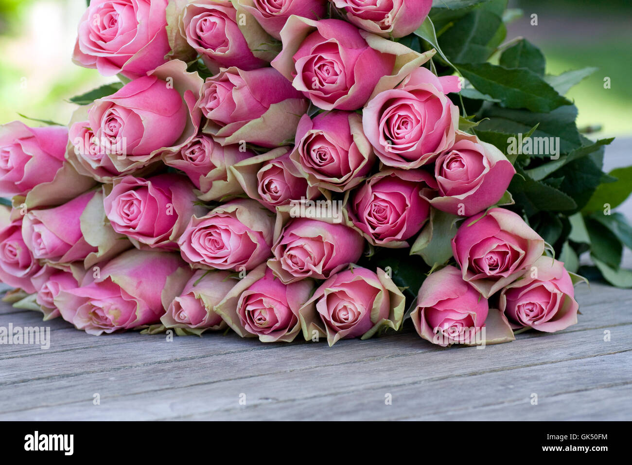 beautiful roses bouquet lying on a wooden table Stock Photo