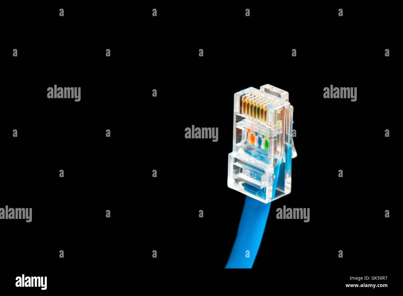 Blue computer ethernet cable isolated on black background, close-up Stock Photo