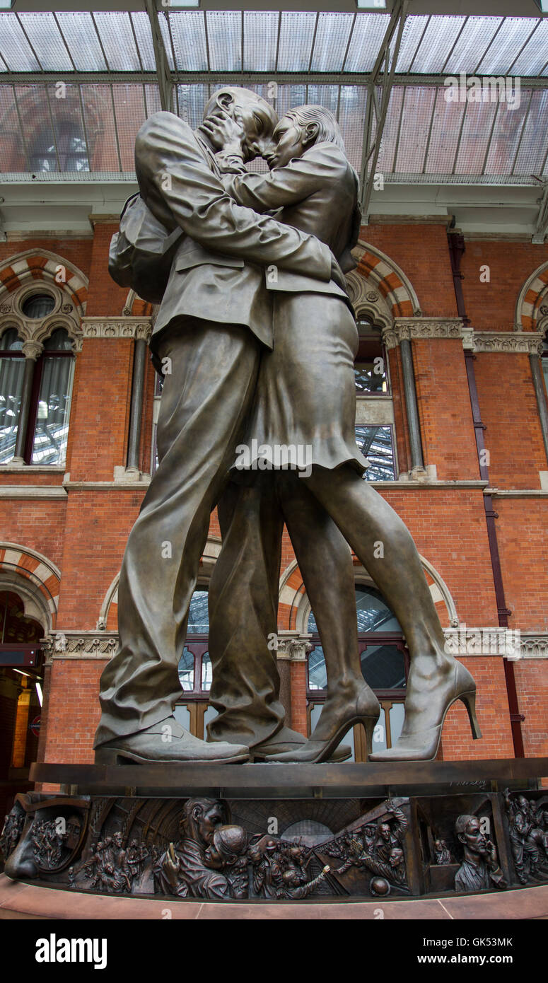 A statue of an intimate couple's embrace by the artist Paul Day which greets railway passengers at St Pancras train station. Stock Photo