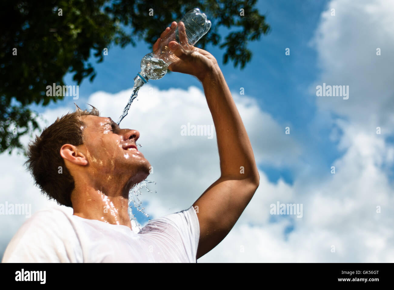 sportsman throwing water over his head for refreshment Stock Photo Alamy