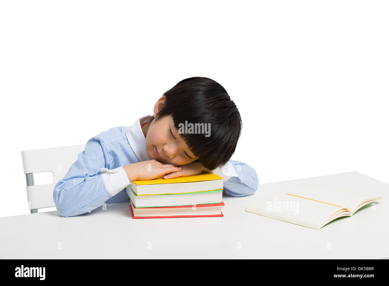 Little boy lying on the desk to sleep Stock Photo