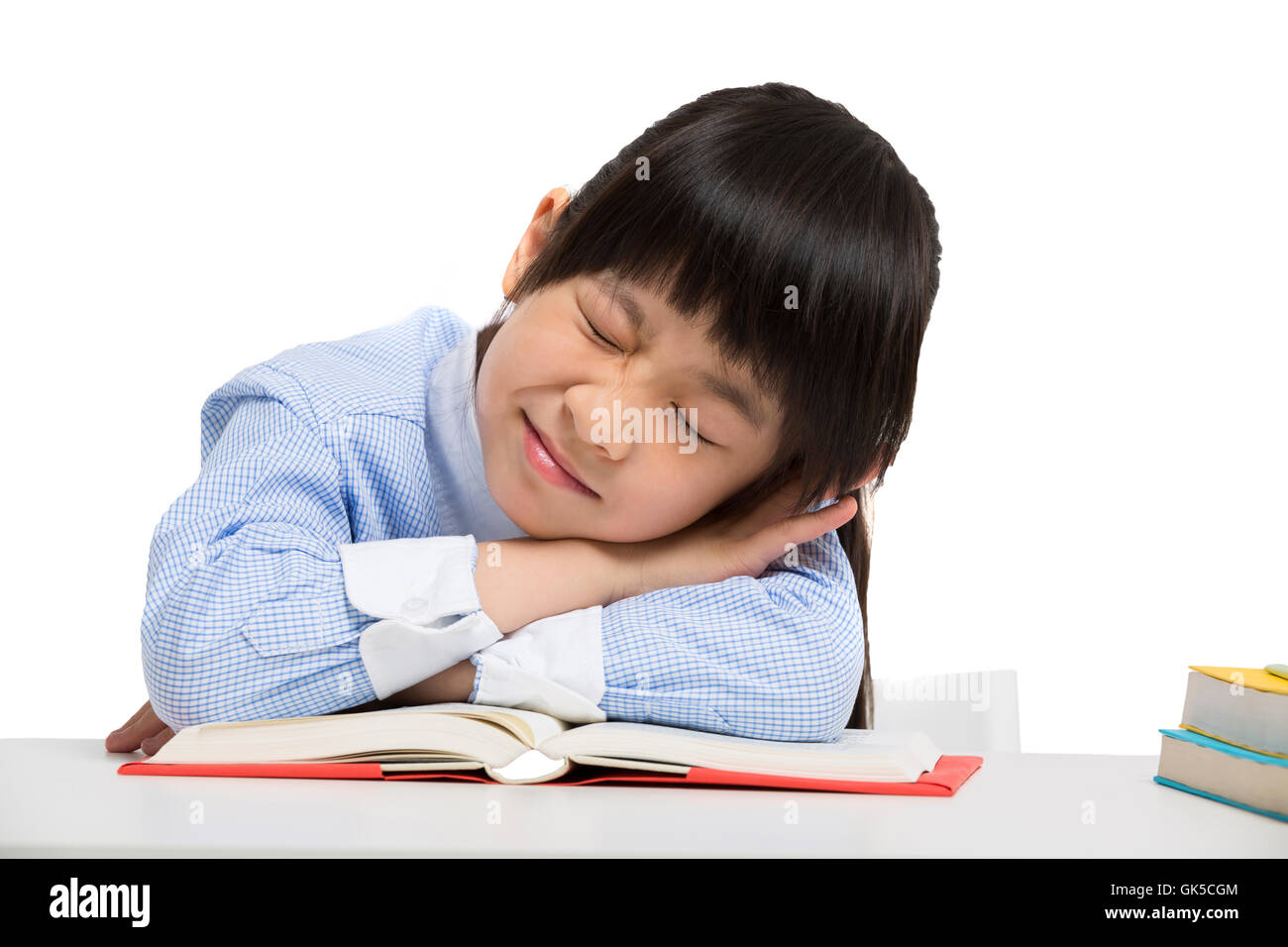 Little girl lying on the desk to sleep Stock Photo