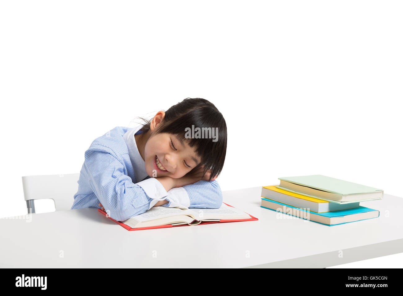 Little girl lying on the desk to sleep Stock Photo