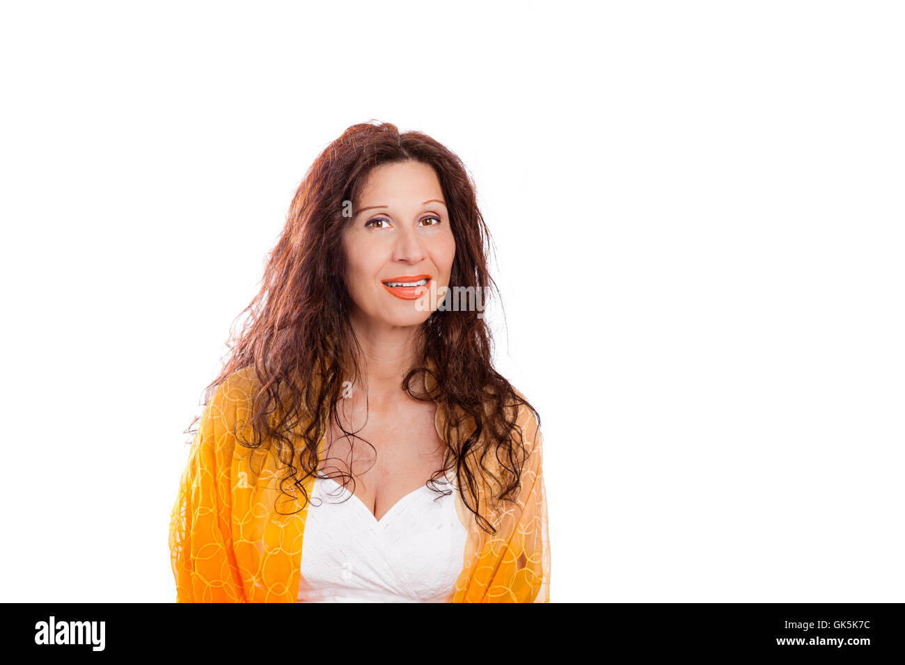 Portrait of gorgeous mature Caucasian woman with Arab and Middle Eastern features smiling while wearing shawl on shoulders against white background Stock Photo