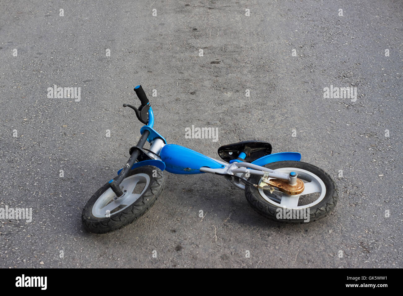 Abandoned bike on road Stock Photo