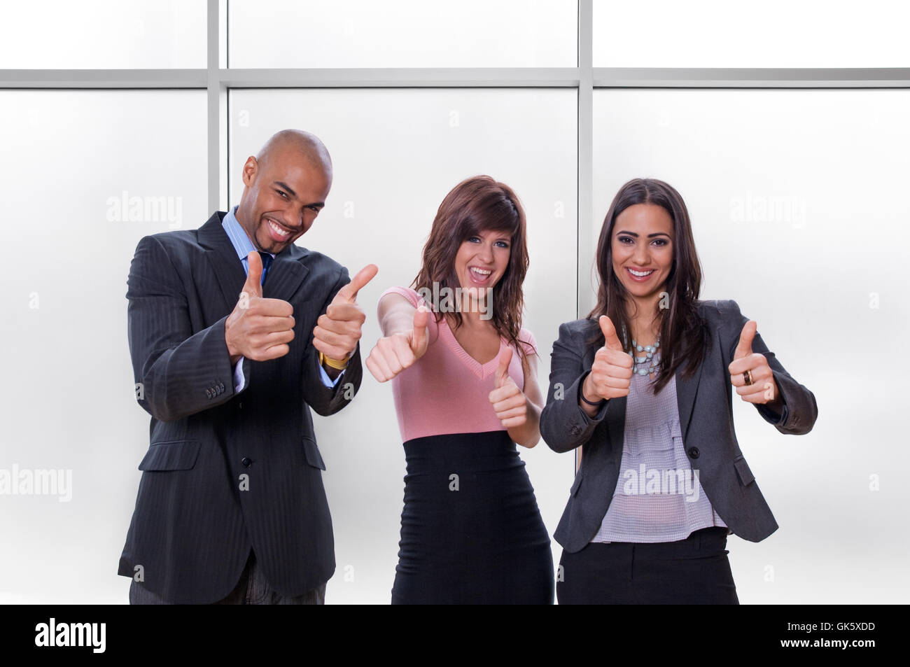 Happy business team thumbs up Stock Photo - Alamy