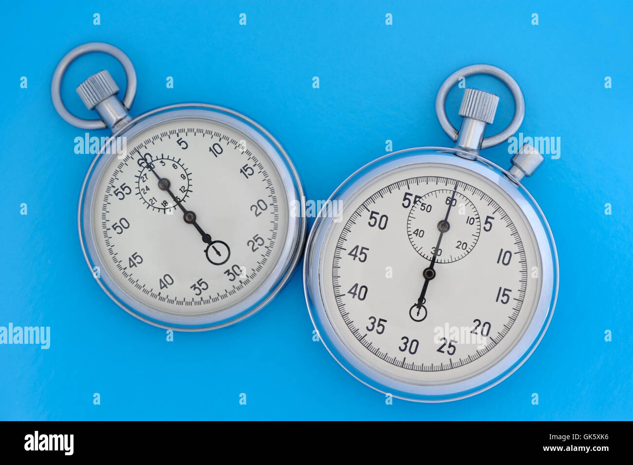 Two stopwatch on blue Stock Photo - Alamy
