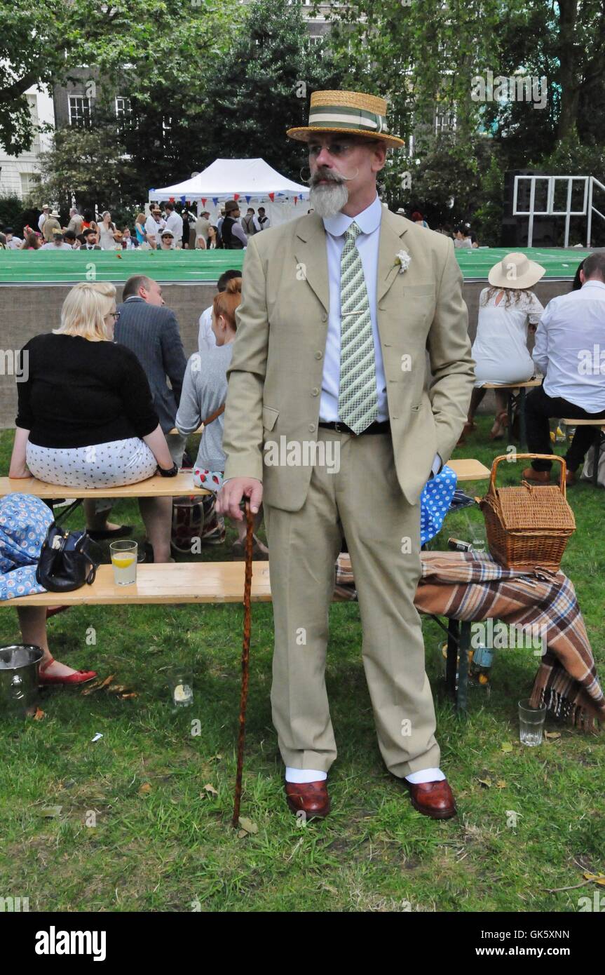 A man wearing a straw boater hat Stock Photo - Alamy